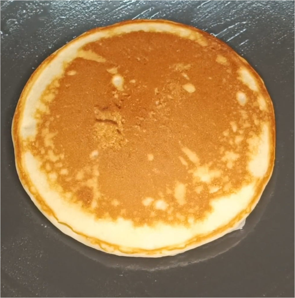 cooking the other side of golden brownish eggless pancake