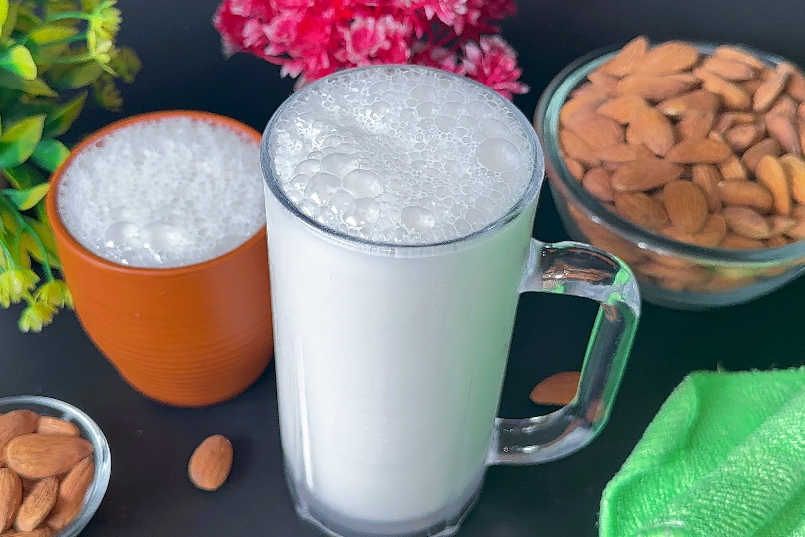 Almond milk served in large glass and traditional clay pot