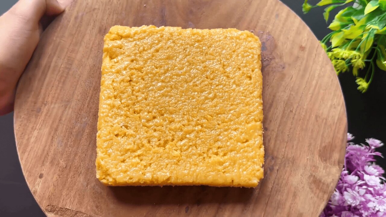 Milk Cake on top of wooden platter ready to be cut in shapes