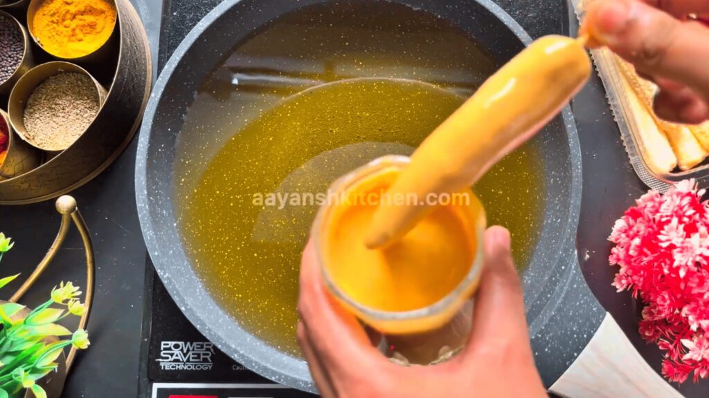 Dipping baby corn in thick batter
