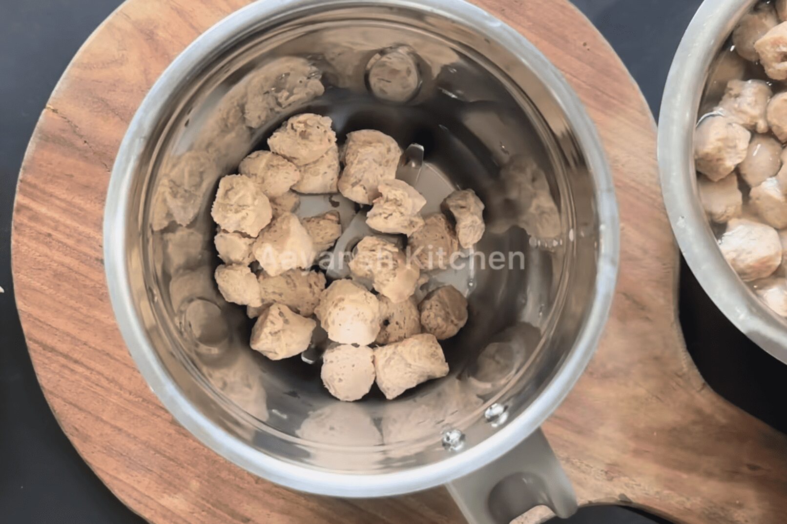 adding soya chunks to a grinder