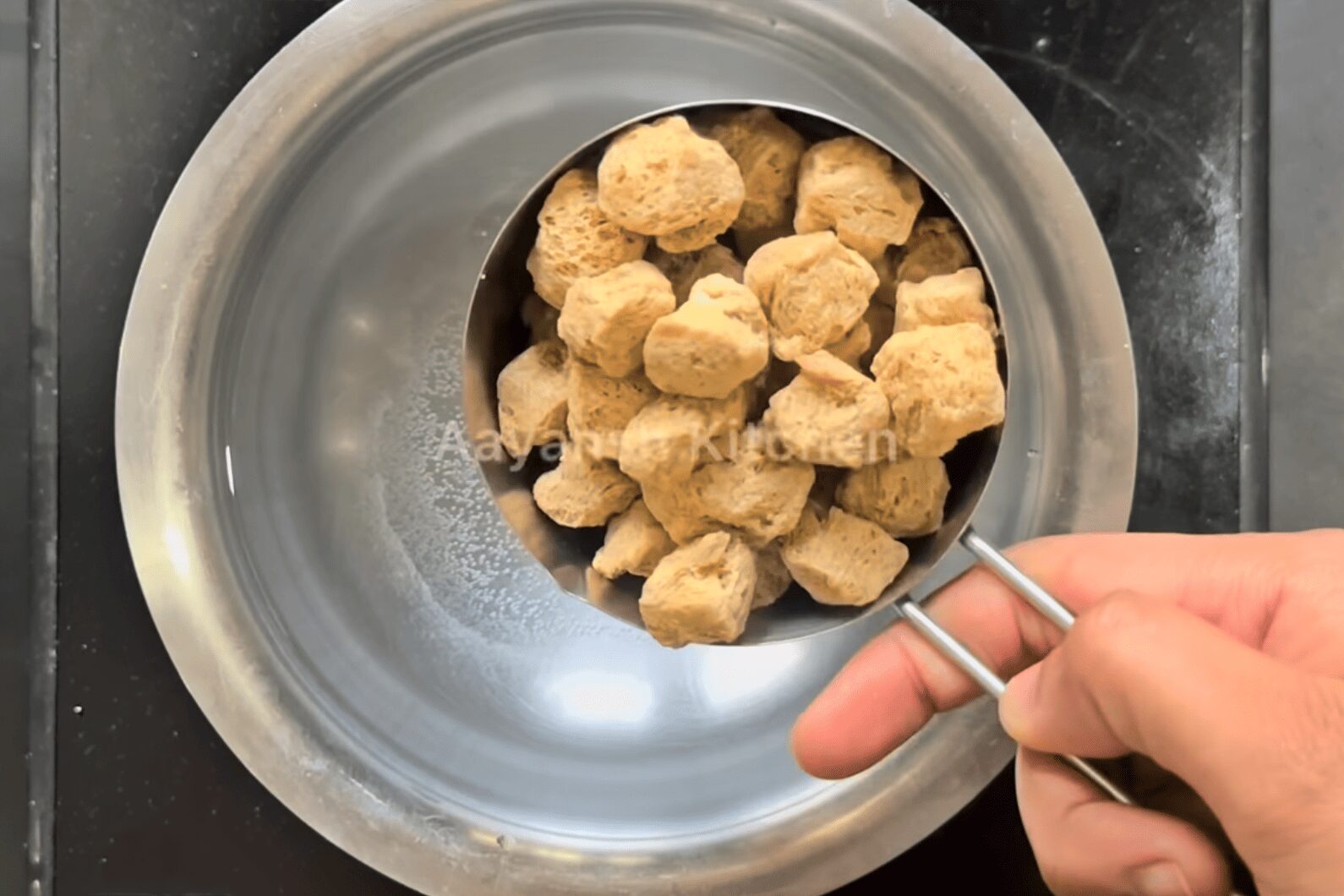 Soya chunks soaking in a pot of warm water to soften for veg kebab recipe