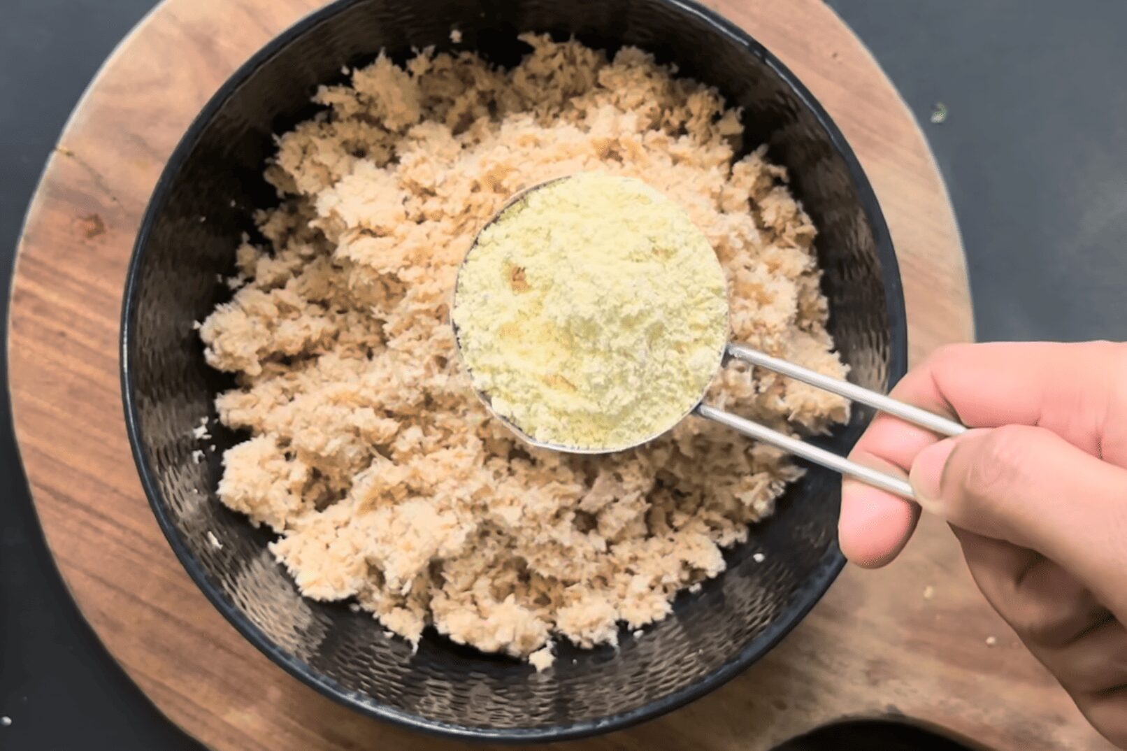 adding besan to the bowl