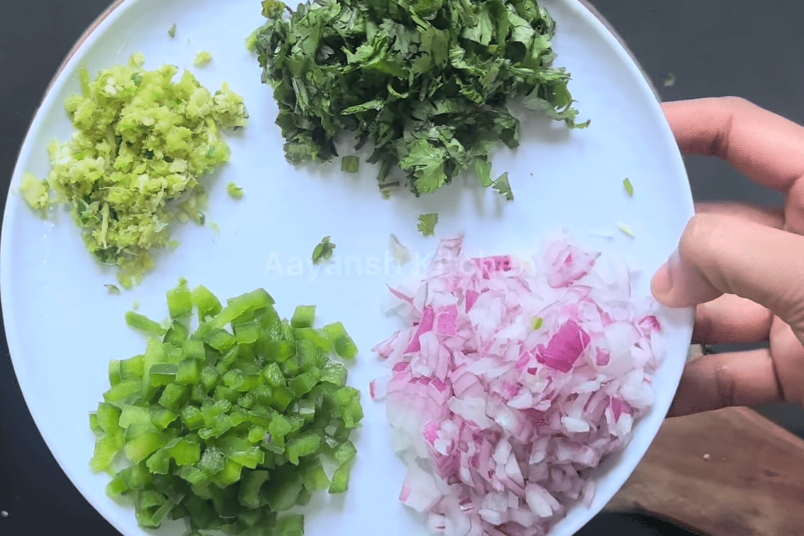 Adding chopped onions, capsicum, coriander, ginger garlic chilli paste to minced soya chunks in a large bowl