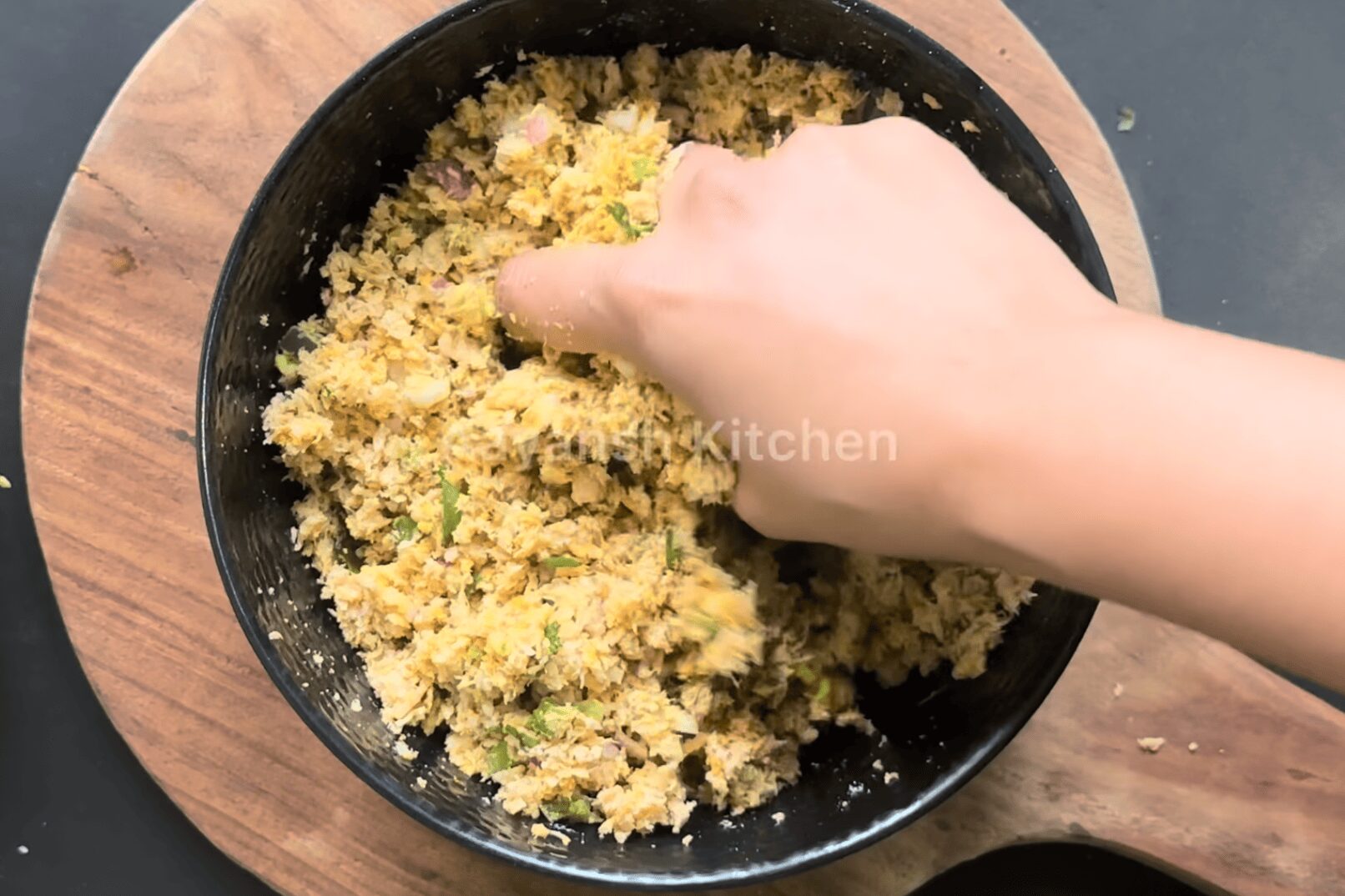 Mixing kebab dough thoroughly with hands to check the binding consistency