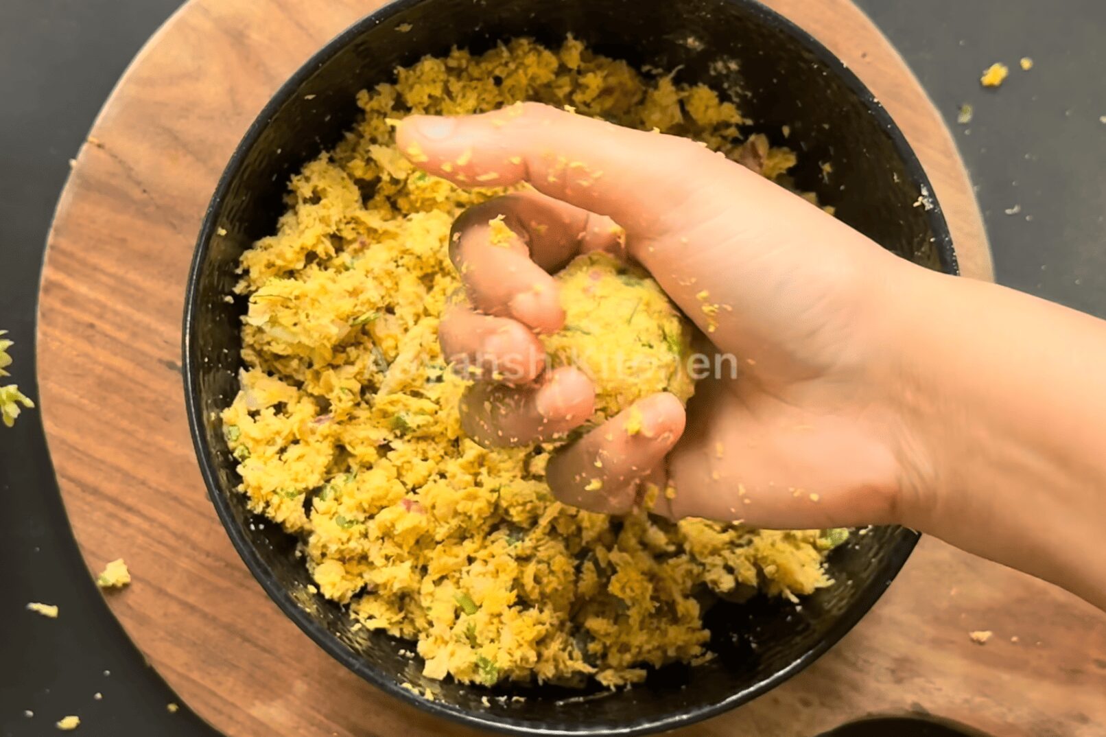 Rolling a big spoonful of mixture to a round ball