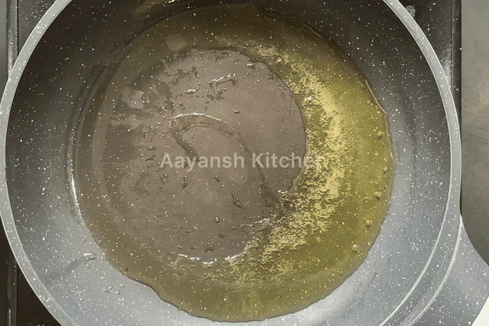 Heating Ghee in a pan to shallow fry the Kebab Patty