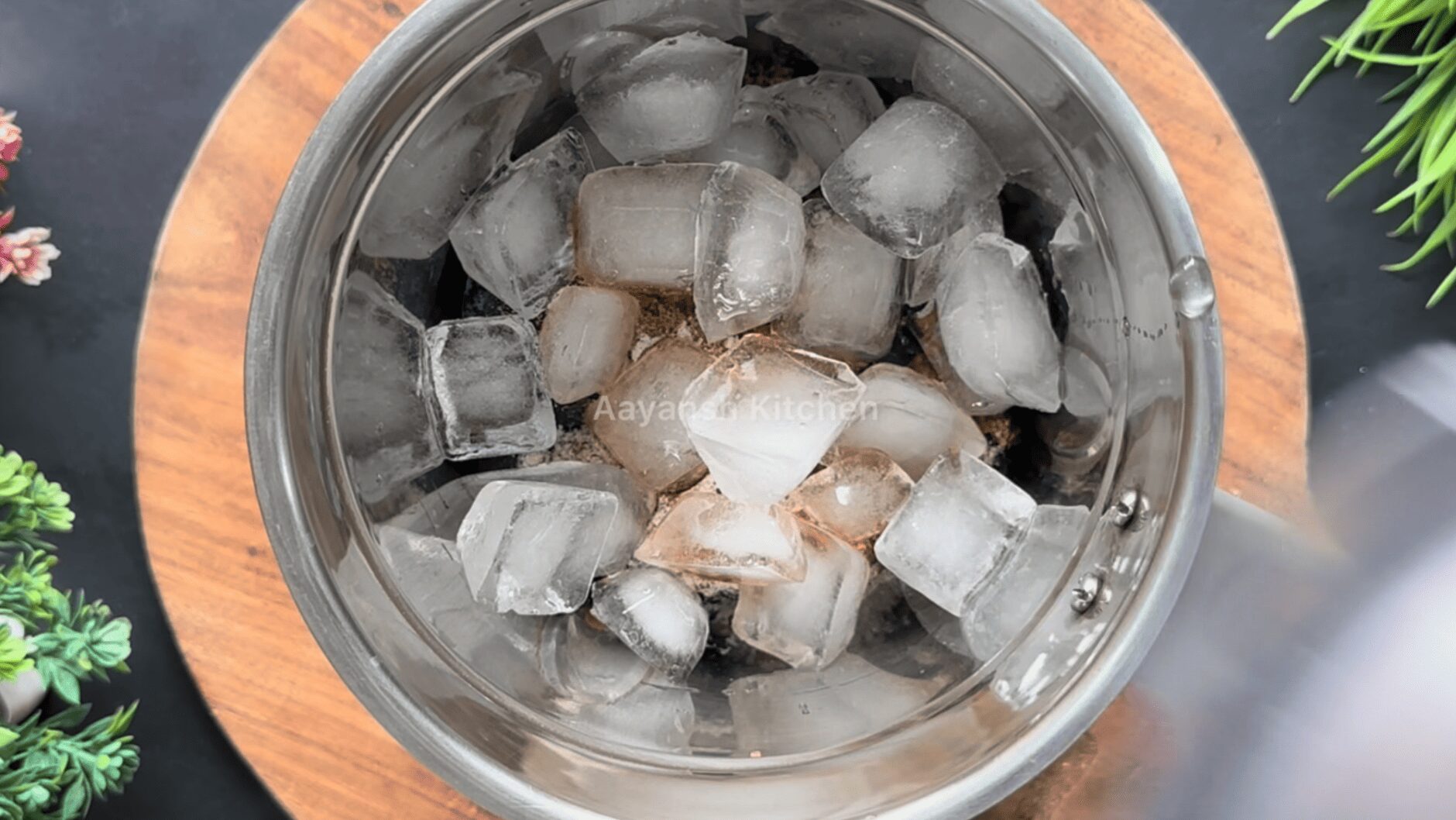 Frozen purple jamun pulp in a blender jar with jaggery powder, roasted cumin, black salt, fresh lemon juice, and ice cubes ready to be blended