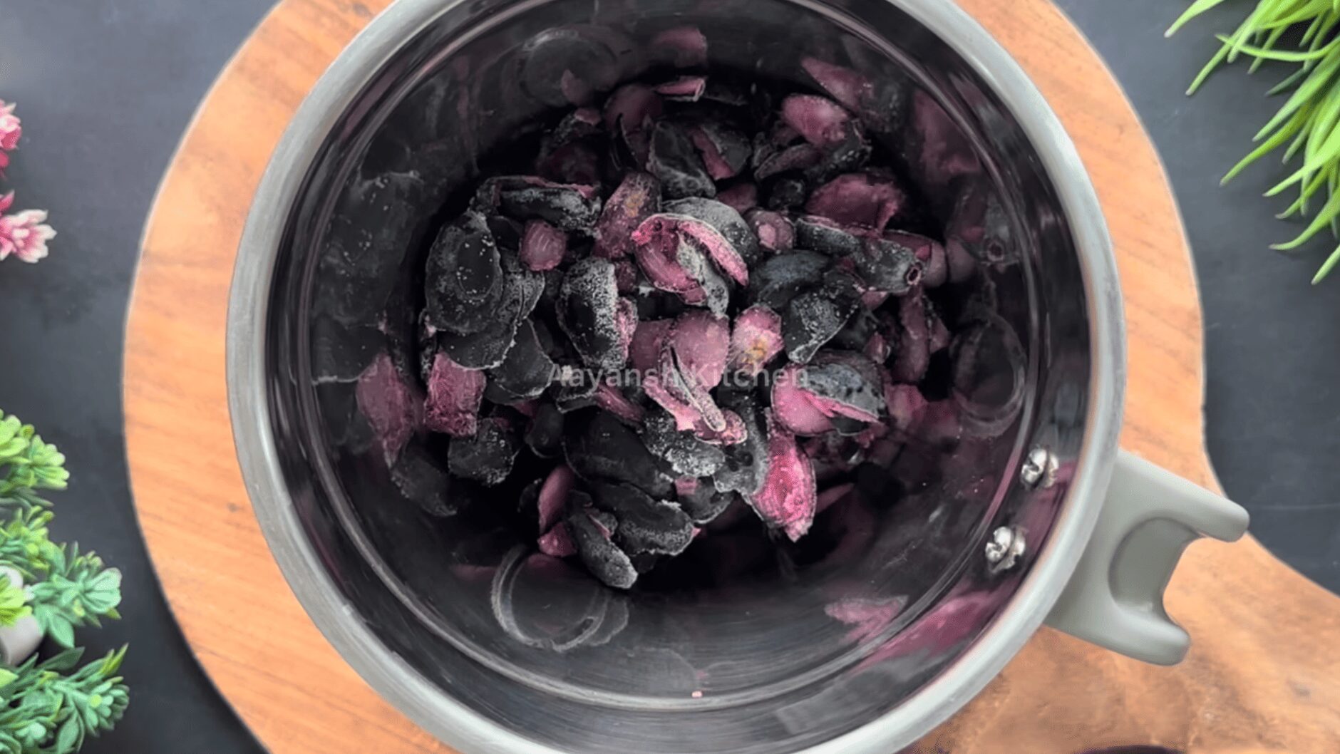 Frozen purple jamun pulp in a blender jar