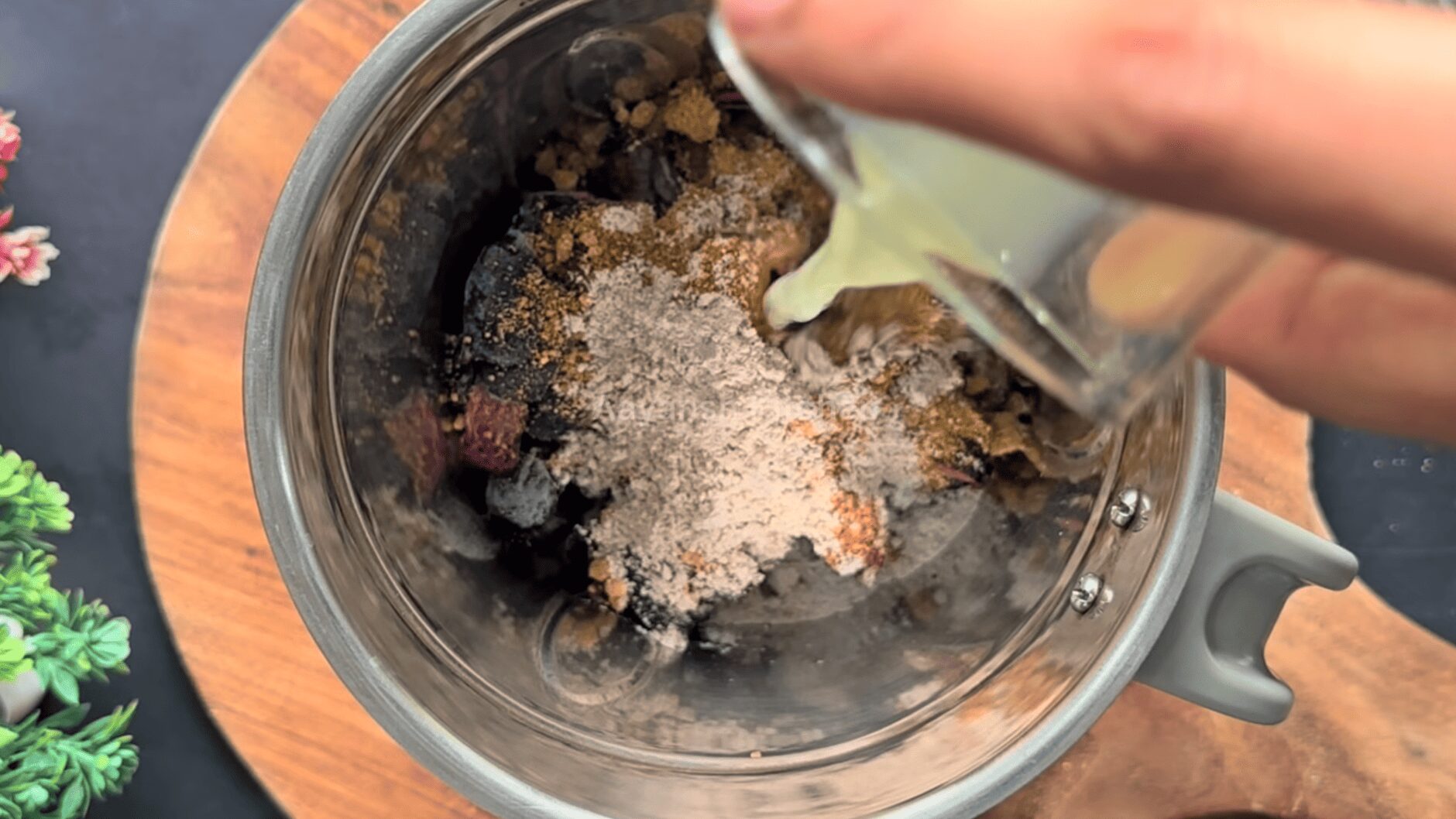 Frozen purple jamun pulp in a blender jar with jaggery powder, roasted cumin, black salt, fresh lemon juice