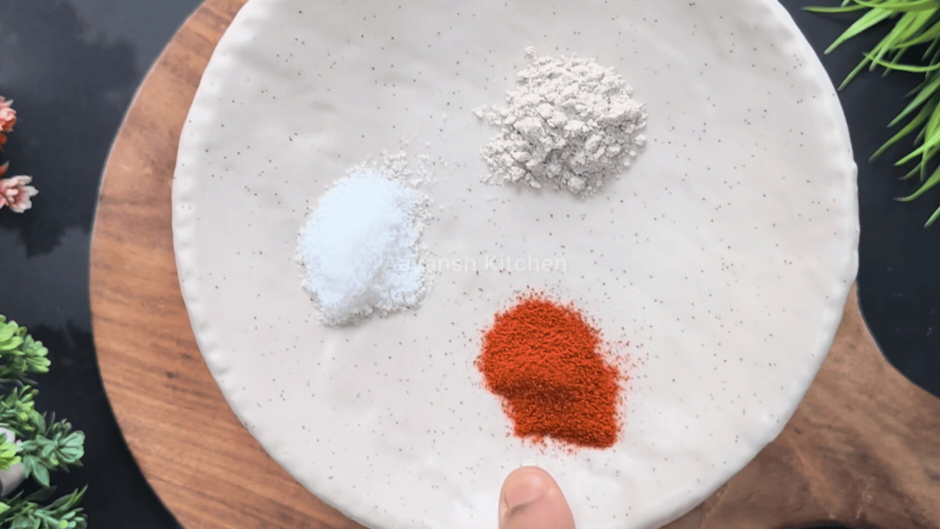 spice mixture of red chili powder and salt on a flat plate